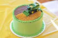 there is a green cake with a tractor on it