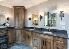 a bathroom with double sinks and wooden cabinets