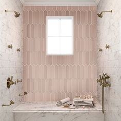 a bathroom with pink and white tiles on the wall, gold fixtures and a window