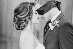 the bride and groom are wearing blindfolds