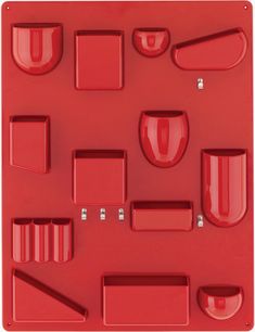 an assortment of red plastic objects on a white background