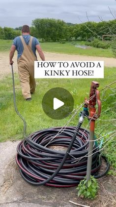 a man is using a hose to water the yard