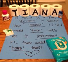 two rolls of toilet paper on top of a table with words written on them and other items