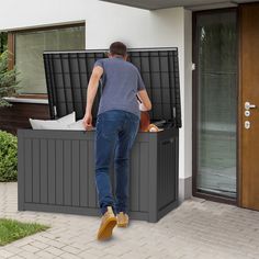 a man standing next to an outdoor storage box