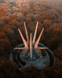 an aerial view of two concrete structures in the middle of a forest