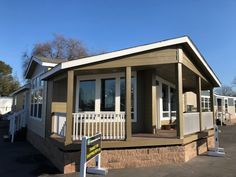 a mobile home is shown with the front porch and stairs up to it's second floor