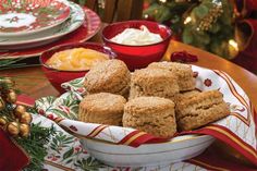 a bowl filled with cookies on top of a table next to other plates and bowls