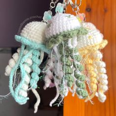 crocheted jellyfish ornament hanging from chain on wooden wall in room