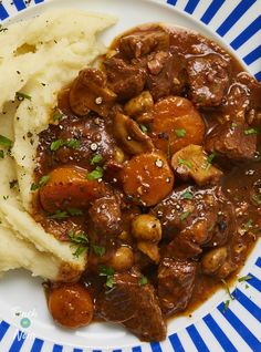 a white plate topped with mashed potatoes and meat