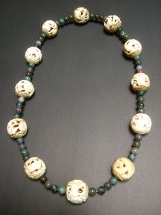 "Massive vintage Chinese artisan zodiac jade beaded necklace The beautiful necklace is embellished with intricately carved ox bone beads depicting the twelve zodiac animals Interspersed within the exotic carved ox bone beads are smaller semi-precious jade beads in muted greens & brownish gray hues The word zodiac derives from the Greek meaning \"circle of figures\" In Chinese terms each of the carved zodiac ox bone beads is represented by an animal beginning with the rat, followed by the ox, Traditional Jade Beaded Necklaces, Traditional Jade Necklace With Gemstone Beads, Traditional Jade Beaded Necklaces With Gemstone Beads, Traditional Handmade Jade Beaded Necklaces, Unique Jade Beaded Necklace With Round Beads, Traditional Hand-strung Jade Beaded Necklace, Unique Carved Beaded Necklace, Unique Jewelry With Carved Round Beads, Unique Carved Round Beads Jewelry