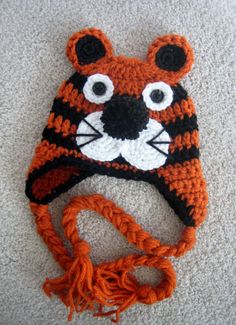 a crocheted tiger hat is laying on the floor