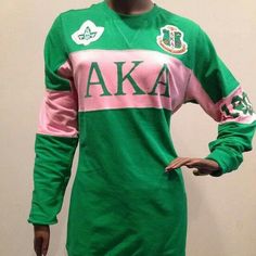 a mannequin wearing a green and pink shirt with the letters aka on it