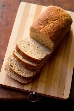 sliced loaf of bread sitting on top of a cutting board