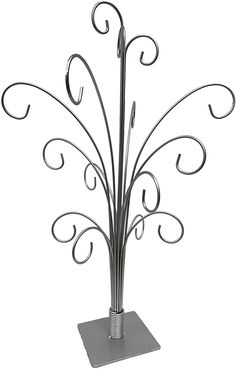 a metal plant stand with two flowers on it's top and one flower in the middle