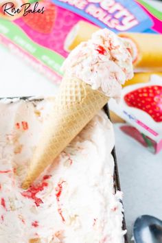 an ice cream sundae with strawberries and whipped cream on top in a pan