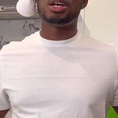 a man in a white shirt wearing a santa hat