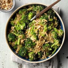 a bowl filled with rice, broccoli and nuts