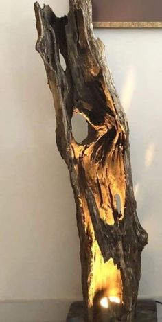 a piece of wood that has been carved to look like a tree trunk with a hole in it