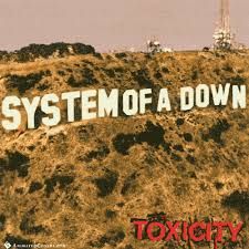 a sign that says system of a down on top of a hill