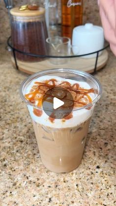 a person is making a drink with ice cream and caramel on the rims