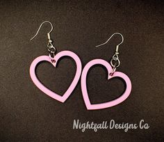 This listing is for these handmade, acrylic, pastel pink heart dangle earrings. Each earring was designed by me and laser cut. This earrings dangle down about 35mmm, or 1.25 inches, and are 2.5cm wide, or about 1.5 inches. They are super lightweight and made with hypoallergenic earring hooks. The fronts of the hearts are matte, and the back is glossy. Please do not hesitate to contact me with any questions you might have, and as always, thank you for supporting small business! Pink Heart Earrings With Ear Wire For Valentine's Day, Trendy Pink Heart Earrings Pierced, Pink Hypoallergenic Dangle Heart Earrings, Hypoallergenic Heart-shaped Pink Earrings, Hypoallergenic Pink Heart Earrings, Cute Pink Pierced Heart Earrings, Pink Open Heart Earrings Gift, Cute Pink Heart Pierced Earrings, Pastel Pink Heart