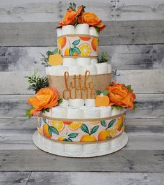 a multi layer cake decorated with orange flowers and burlocks