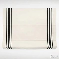 a black and white checkered table cloth with horizontal stripes on the border, hanging from a wall