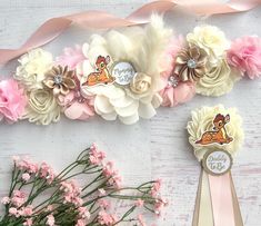 some flowers and ribbons on a white table