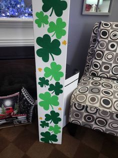 a st patrick's day decoration with shamrocks painted on the side of it