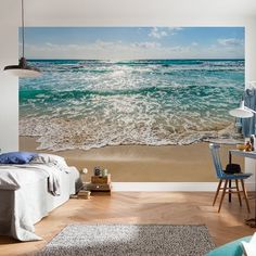 an ocean scene with waves crashing on the beach wallpaper mural in a living room