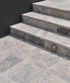 the steps are made of stone and have metal handles