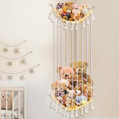 a crib filled with lots of stuffed animals next to a wall mounted teddy bear