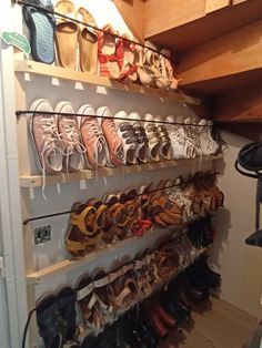 there are many pairs of shoes hanging on the wall