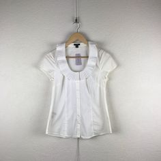 Ann Taylor L 2p Classic Poplin Pleated Ruffle Collar Scoopneck Button Down Shirt. Fits Approximately : Extra Small To Small; Label States 2p - Garment Has Stretch. Bust : 32” Length : 24” Nwt. Excellent Condition. Never Worn. 0580 New To Poshmark? Use Code "Shesabettie" For $10 Off Your First Purchase! Office Tops With Button Closure And Ruffled Collar, Office Tops With Peter Pan Collar And Buttons, Workwear Blouse With Ruffled Collar And Buttons, Workwear Blouse With Buttons And Ruffled Collar, Workwear Tops With Peter Pan Collar And Button Closure, Peter Pan Collar Tops With Buttons For Office, Ruffled Collar Tops With Button Closure For Work, Ruffled Collar Workwear Top With Button Closure, Fitted Tops With Ruffled Collar For Work