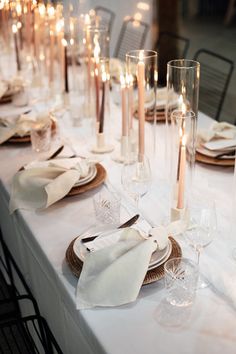 the table is set with candles and place settings