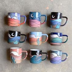 six coffee mugs are lined up on the floor with different designs painted on them