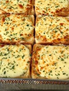 several square pieces of bread with cheese and herbs