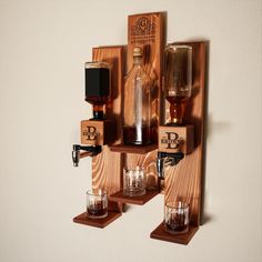 a wall mounted liquor bottle dispenser and glasses on wooden shelves with labels