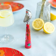 a table topped with plates and glasses filled with lemonade next to a cocktail shaker