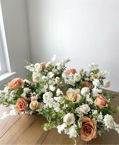 a bouquet of flowers sitting on top of a wooden table