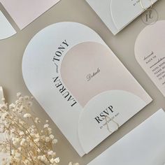 the wedding stationery is laid out on top of each other