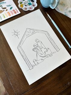 a drawing of a nativity scene on a table