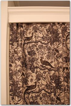 a curtain with birds and flowers on it