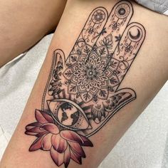 a woman's arm with a tattoo on it and a hand holding a flower