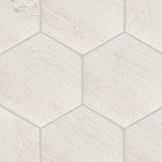 a white hexagonal tile pattern with wood grains