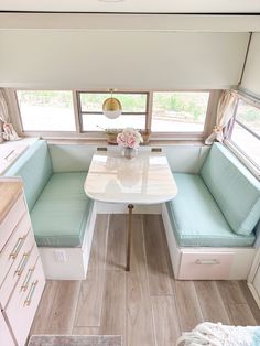 the interior of a mobile home with a kitchen and dining room table in front of it