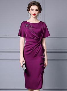 Phosphorescently radiant, this mother of the bride dress in a luxurious plum hue blends classic elegance with contemporary style. The dress features a unique asymmetrical ruffle detail that adds a modern twist to the traditional silhouette. The bodice is adorned with delicate embellishments, providing a touch of sparkle that draws attention to your face. The fabric drapes gracefully, offering both comfort and a flattering fit. The short sleeves provide a modest yet chic look, suitable for variou Delicate Gown, Elegant Party Dress, Office Dresses For Women, Satin Short, Elegant Party Dresses, White Dress Party, Purple Satin, Mother Of The Bride Dress, Elegant Party