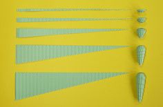 several pieces of paper are arranged on a yellow surface