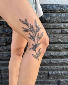 a close up of a person's legs with leaves on them