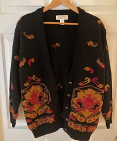 "Features 🥰 Brand:  Jones of New York (JNY) Original Purchase:  Nordstrom's @ $225.00 (winter designer wear) Style:   Women's Cardigan Sweater Size:  Medium (M) Condition:  Excellent, pre-owned, worn twice Material:  100% Wool (soft but thick, well-constructed) Pattern:  Multi-Colored  Fabric Type:  Knit Accents:  Hand-Embroidered Appliques  Color: black, red, golden brown Neckline:  V-Neck Closure:  Decorative Embossed Metal Buttons Features:  Button-Down, Perfect for Winter Occasion:  Career Black Embroidered Cardigan For Fall, Embroidered Black Cardigan For Fall, Embroidered Wool Sweater For Fall, Embroidered Red Cardigan For Fall, Red Embroidered Fall Cardigan, Vintage Black Cardigan With Button Closure, Vintage Embroidered Cardigan For Fall, Fall Vintage Embroidered Cardigan, Traditional Fall Outerwear With Buttons